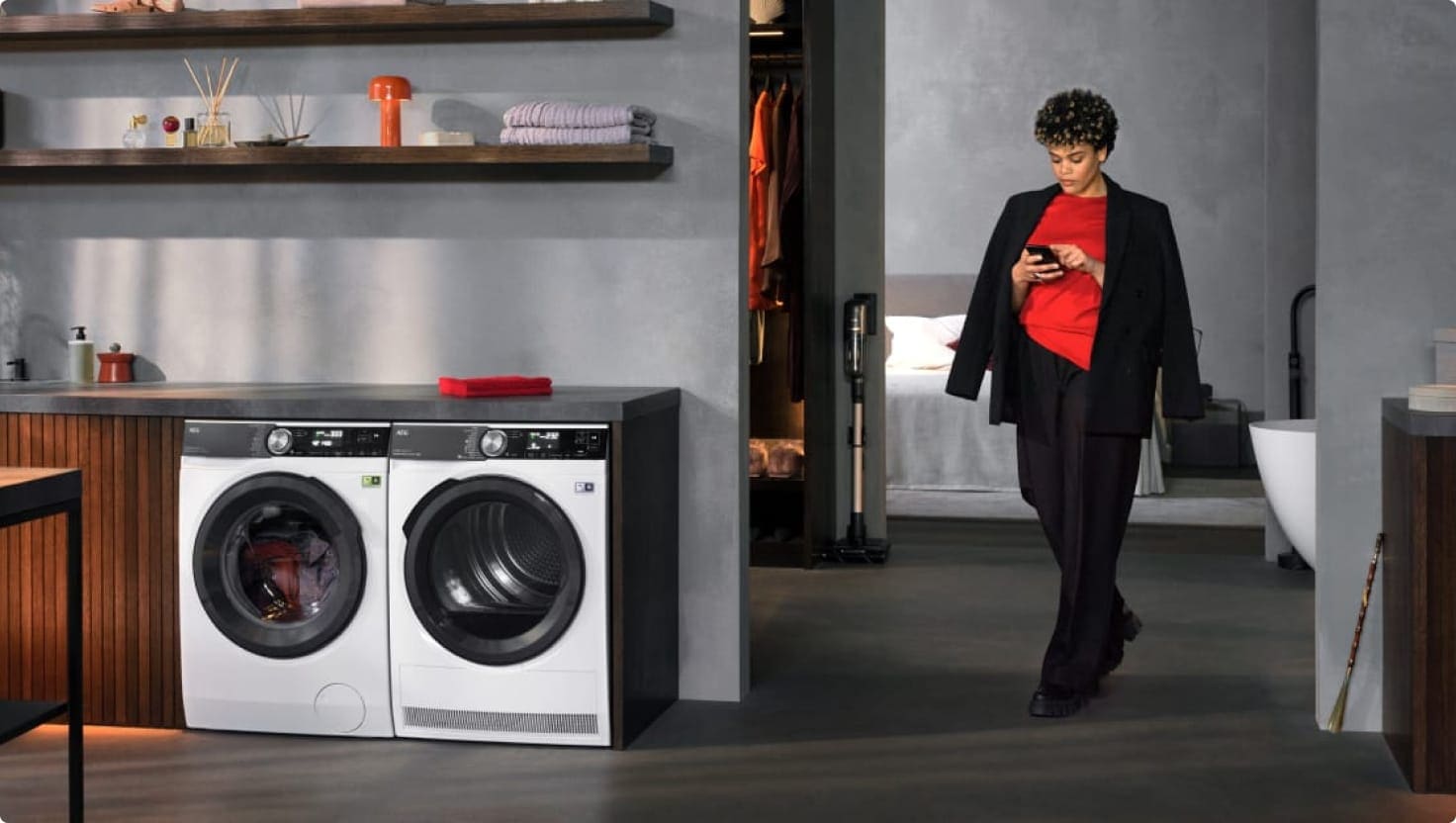 Woman walking into a laundry room.